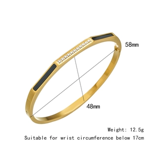 Vue détaillée du bracelet doré ondulé avec émail noir et cristaux scintillants de 58mm