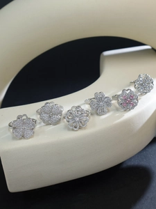Macro shot of silver four-leaf clover rings with sparkling zircon and pink stones