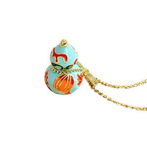 Vintage Chinese style gourd necklace with blue enamel pendant and gold chain on white background
