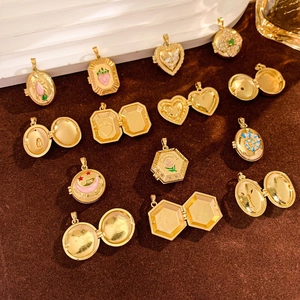 Detail of vintage gold-plated locket pendants with colorful engravings and photo compartments