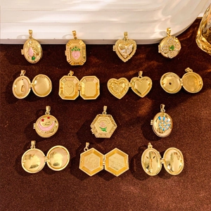 Detail of vintage gold lockets in various shapes with enamel patterns and photo slots