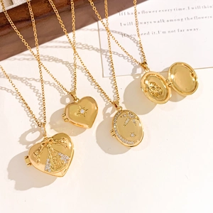 Golden locket necklaces set with star and angel designs on an aesthetic card