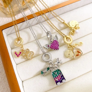 Exquisite 18K gold-plated necklaces with zircon hearts, bee, and airplane charms in a box