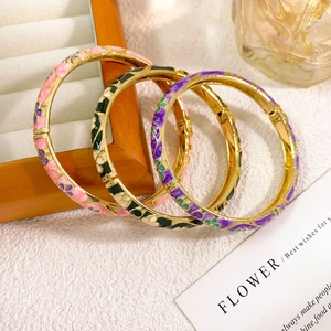 Three Chinese-style cloisonne enamel flower bangles with vintage gold-finish patterns