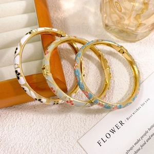 Three-piece set of vintage cloisonné enamel floral bangles in gold-plated finish