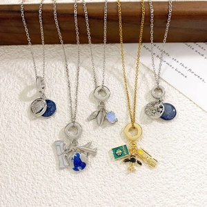 Travel theme pendant necklaces set with camera, passport, globe and moon designs