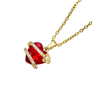 Elegant gold necklace with deep red heart crystal and delicate floral diamond accents