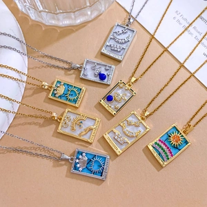 Gold and silver tarot card necklaces featuring Sun, Moon, and Empress motifs with crystals
