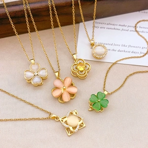 Elegant gold necklaces with spinning opal flower pendants in multiple colors and designs
