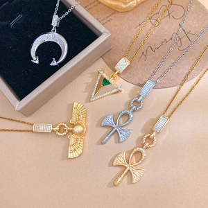 Collection of geometric cross and crescent moon necklaces in gold and silver titanium steel