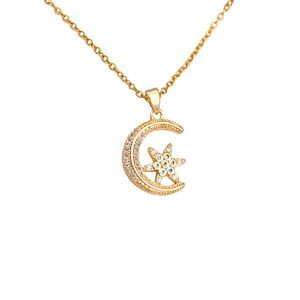 Elegant gold celestial necklace featuring a crescent moon and star pendant with zircons