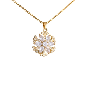 Gold-plated stainless steel necklace with sparkling snowflake pendant and pearl accents