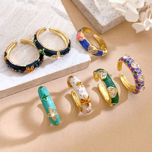 Colorful enamel floral open rings with heart stars and rhinestones on stone background