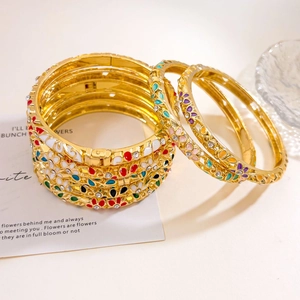 Golden bangle set with colorful enamel flowers and shimmering zircon crystals