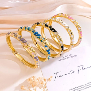 Set of five colorful enamel flower bangles with gold plating and sparkling crystals