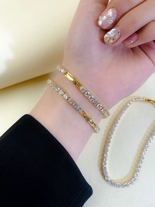 Detail of adjustable gold tennis bracelets with sparkling cubic zirconia on a wrist