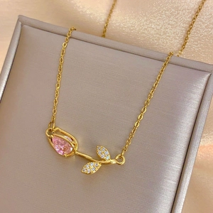 Elegant gold tulip necklace with a pink pear-shaped gemstone and shimmering leaf accents