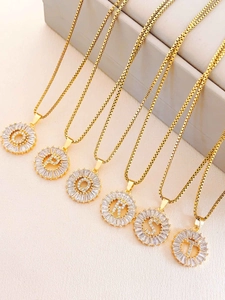 Detailed shot of golden alphabet pendants O to T with sparkling crystal settings