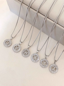 Detailed view of silver letter pendants U-Z with cubic zirconia and box chain necklaces