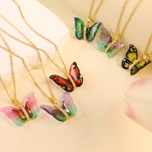 Colorful butterfly pendant necklace with crystal accents on a dainty gold chain