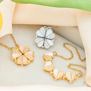 Golden heart clover necklace and bracelet set with pink shell inlay on soft velvet