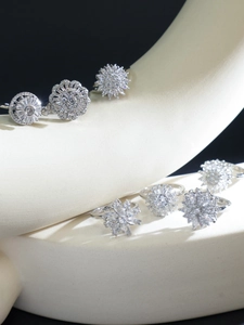 Artistic macro view of diverse floral zircon rings on white stone blocks with black background