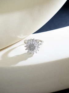 Macro shot of silver rotating flower ring with sparkling marquise cut zircons