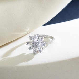 Rotating flower zircon ring in silver finish with sparkling petal-shaped crystals