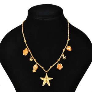 Colorful woven cord necklace with starfish and sea animal charms on a black display stand
