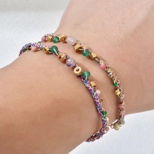 Bohemian handmade braided bracelet set with natural stones and golden metal beads on wrist