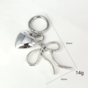 Silver metal keychain with 3D heart and bow pendant, dimensions 83mm by 42mm