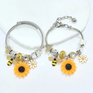 Detailed set of silver stainless steel bracelets with sunflower, bee and star charms