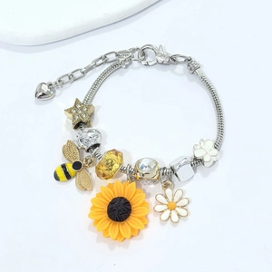 Silver snake chain bracelet featuring sunflower and bee charms with yellow faceted beads