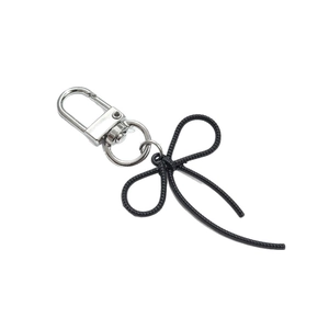 Fashionable black woven bow keychain with a polished silver lobster clasp for bags