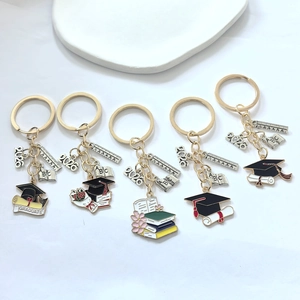 Close-up of assorted graduation keychains featuring colorful drip oil alloy charms for 2026