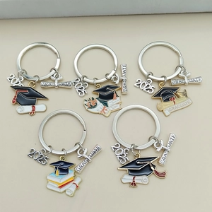 Detail of 2025 graduation keychains with colorful enamel doctoral caps and books