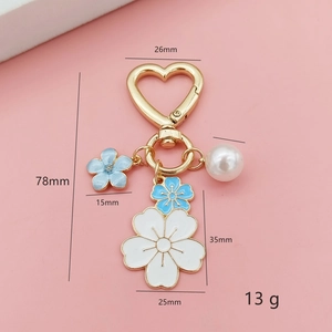 Cute cherry blossom heart keychain with enamel flowers, pearl, and gold metal clasp