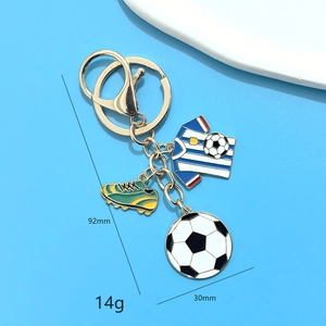 Detail view of soccer keychain with blue striped jersey, shoe and ball charms