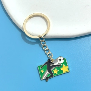 Detail view of soccer player keychain with green enamel finish and golden ring