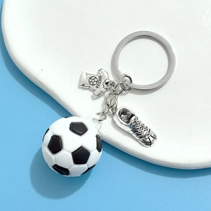 Détail d'un porte-clés de football avec ballon, pendentif de maillot argenté et chaussure