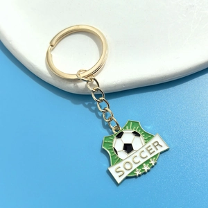 Detail of shield-shaped soccer keychain with green enamel and golden star accents