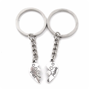 Detail of Best Friends split heart keychains in vintage silver finish with engraved text