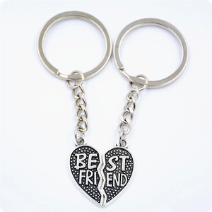 Macro detail of the Best Friend split heart keychains with textured silver finish