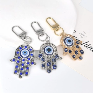 Vintage Hamsa Hand and Evil Eye metal keychains in gold and silver finish with blue accents
