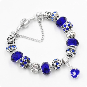 DIY charm bracelet with blue crystal beads and vintage silver pendants on snake chain