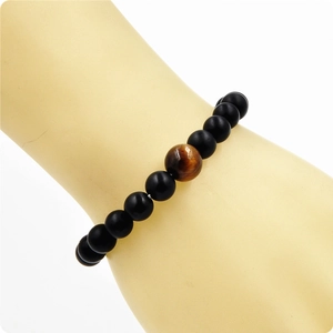 Mens beaded bracelet with matte black stone beads and a natural tiger eye focal stone