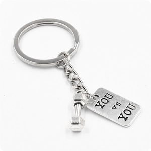 Retro dumbbell keychain with 'YOU VS YOU' engraved tag in polished silver alloy