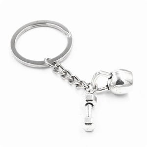 Vintage silver fitness keychain featuring barbell and kettlebell charms on a metal ring