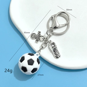 Detail view of soccer keychain featuring a mini ball, heart charm, and cleat with measurements
