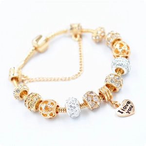 Detail of golden charm bracelet with I love you heart pendant and security chain